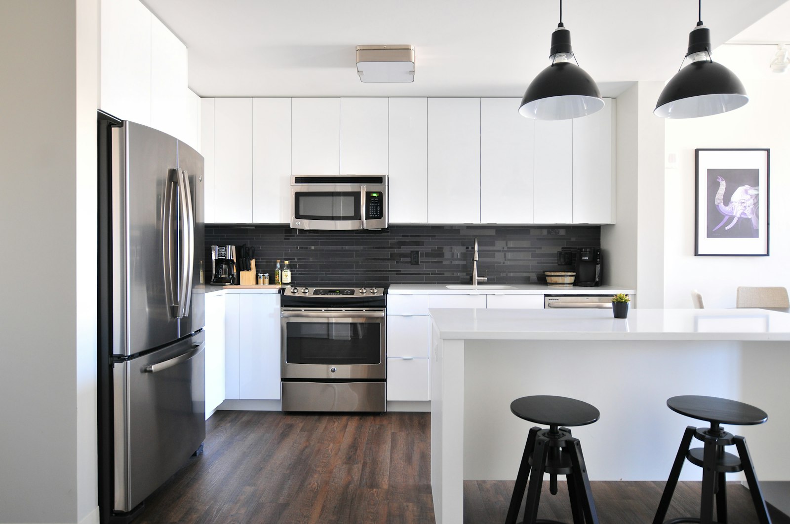 A bright kitchen with freshly painted white walls and cabinets